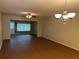 Spacious living room featuring wood floors, a ceiling fan, and a view to the front of the house at 2410 Franciscan Dr # 18, Clearwater, FL 33763