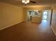 Bright living room with wood floors flowing into the kitchen, creating an inviting open-concept space at 2410 Franciscan Dr # 18, Clearwater, FL 33763