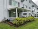 Outdoor patio featuring well-maintained landscaping and building exterior at 2410 Franciscan Dr # 18, Clearwater, FL 33763