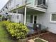 Outdoor patio featuring well-maintained landscaping and building exterior at 2410 Franciscan Dr # 18, Clearwater, FL 33763