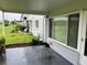 View of the enclosed patio with a well-manicured lawn and garden at 2410 Franciscan Dr # 18, Clearwater, FL 33763