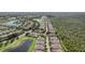 Community aerial view showcasing beautiful homes, serene lakes, and lush greenery in a well-maintained neighborhood at 2427 Nottingham Greens Dr, Sun City Center, FL 33573