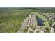 Community aerial view showcasing lovely homes, serene lakes, and lush green spaces in a well-maintained neighborhood at 2427 Nottingham Greens Dr, Sun City Center, FL 33573