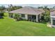 Expansive backyard featuring screened lanais, lush lawn, and vibrant landscaping ideal for outdoor living at 2427 Nottingham Greens Dr, Sun City Center, FL 33573