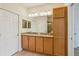 Bathroom with dual sinks, granite counters, and two doors at 2427 Nottingham Greens Dr, Sun City Center, FL 33573
