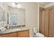 Bright bathroom with granite countertop vanity, shower and neutral finishes at 2427 Nottingham Greens Dr, Sun City Center, FL 33573