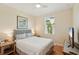 Cozy bedroom with hardwood floors, a queen-sized bed, and a ceiling fan at 2427 Nottingham Greens Dr, Sun City Center, FL 33573