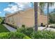 Cream colored house exterior with two-car garage and well maintained landscaping at 2427 Nottingham Greens Dr, Sun City Center, FL 33573