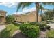 Well-maintained home showcasing lush landscaping, a spacious driveway, and a charming front exterior at 2427 Nottingham Greens Dr, Sun City Center, FL 33573