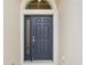Stylish navy blue front door featuring a side window panel and a classic, inviting design at 2427 Nottingham Greens Dr, Sun City Center, FL 33573