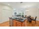 Open kitchen with center island, eat in dining, and view of the spacious living room at 2427 Nottingham Greens Dr, Sun City Center, FL 33573