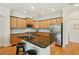 Spacious kitchen features an island with bar seating and stainless steel appliances at 2427 Nottingham Greens Dr, Sun City Center, FL 33573