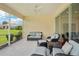 Screened lanai featuring comfortable seating and tranquil views of outdoor landscape at 2427 Nottingham Greens Dr, Sun City Center, FL 33573