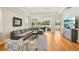 Spacious living room featuring contemporary furnishings, large sliding glass doors, and ample natural light at 2427 Nottingham Greens Dr, Sun City Center, FL 33573