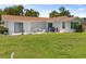 Backyard of a home with green grass, patio, and various tables and chairs at 2436 Nuremberg Blvd, Punta Gorda, FL 33983