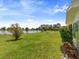 Backyard featuring beautiful green space, a tranquil pond view, and privacy at 2436 Nuremberg Blvd, Punta Gorda, FL 33983