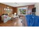 Cozy living room featuring hardwood floors, wood paneling, a large window, and comfortable furnishings at 2436 Nuremberg Blvd, Punta Gorda, FL 33983