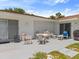 Outdoor patio with seating, ideal for relaxing or entertaining, featuring bright sunlight and an expansive backyard at 2436 Nuremberg Blvd, Punta Gorda, FL 33983