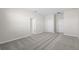 A bright and airy bedroom featuring neutral carpeting, paint, and two access doors at 2589 Winding Creek Trl, North Port, FL 34289