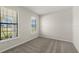 Bright bedroom features plush carpeting, fresh paint, and sun-filled windows at 2589 Winding Creek Trl, North Port, FL 34289