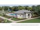 Community clubhouse features a pool, lounge seating, and is surrounded by lush landscaping at 2589 Winding Creek Trl, North Port, FL 34289