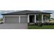 Beautiful single-story home with a two-car garage, neutral paint, and professional landscaping at 2589 Winding Creek Trl, North Port, FL 34289
