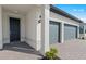 Modern home featuring a stylish front door, two-car garage, and a well-manicured brick driveway and landscaping at 2589 Winding Creek Trl, North Port, FL 34289