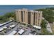 An aerial view of a tan apartment building overlooking the water and covered parking at 2617 Cove Cay Dr # 707, Clearwater, FL 33760