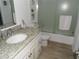 Bright bathroom featuring a granite countertop, modern fixtures, and a glass enclosed shower at 2617 Cove Cay Dr # 707, Clearwater, FL 33760