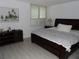 Inviting bedroom with a large window and a dark wood frame bed at 2617 Cove Cay Dr # 707, Clearwater, FL 33760