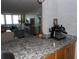 Stylish kitchen with granite countertops, coffee bar, and open living space at 2617 Cove Cay Dr # 707, Clearwater, FL 33760