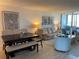 Living room featuring a dining table, water views, and comfortable seating arrangements at 2617 Cove Cay Dr # 707, Clearwater, FL 33760
