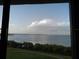 Water view through the window over lush green landscape at 2617 Cove Cay Dr # 707, Clearwater, FL 33760