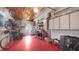 Unfinished basement with red floor and laundry area at 2807 Miriam S St, Gulfport, FL 33711