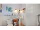 Bathroom featuring white tile, a pedestal sink, and decorative artwork, offering a clean and bright space at 2807 Miriam S St, Gulfport, FL 33711