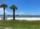 Scenic beach view with palm trees and boats in the distance at 2807 Miriam S St, Gulfport, FL 33711