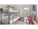 Bedroom featuring a bunk bed, tile floors, and access to a sunroom, blending comfort with functionality at 2807 Miriam S St, Gulfport, FL 33711