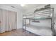 Bedroom with a metal bunk bed and tile flooring, offering a practical and functional space at 2807 Miriam S St, Gulfport, FL 33711
