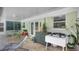 Covered outdoor area featuring stylish shutters, a dining set, and additional seating at 2807 Miriam S St, Gulfport, FL 33711