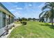 Spacious backyard offers lush green grass and serene landscaping, providing an ideal setting for outdoor activities and relaxation at 302 Andover Pl # G156, Sun City Center, FL 33573