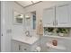 Clean and white bathroom with nice cabinets, hardware and lighting at 302 Andover Pl # G156, Sun City Center, FL 33573