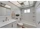 Bright white bathroom with shower-tub combo, white cabinets and lots of space at 302 Andover Pl # G156, Sun City Center, FL 33573