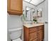 Updated bathroom with modern vanity, mirror, wood-look floor, and stylish fixtures at 302 Andover Pl # G156, Sun City Center, FL 33573