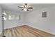 Bedroom with natural light, fan, laminate flooring, and minimalist aesthetic at 302 Andover Pl # G156, Sun City Center, FL 33573
