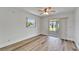 Bright bedroom featuring stylish laminate flooring, a ceiling fan and sliding glass doors at 302 Andover Pl # G156, Sun City Center, FL 33573