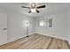 Bright bedroom featuring wood-look flooring, fan, and a window for natural light at 302 Andover Pl # G156, Sun City Center, FL 33573