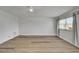 Serene room with modern floors, a fan, and a window that lets in natural light with white walls at 302 Andover Pl # G156, Sun City Center, FL 33573