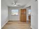 Cozy room with updated flooring, built-in cabinets and a ceiling fan at 302 Andover Pl # G156, Sun City Center, FL 33573