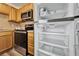 Kitchen featuring stainless steel appliances, wood cabinets, and a spacious, modern refrigerator at 302 Andover Pl # G156, Sun City Center, FL 33573