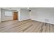 Inviting living area with updated floors, a ceiling fan, and a glimpse of the adjacent kitchen space at 302 Andover Pl # G156, Sun City Center, FL 33573